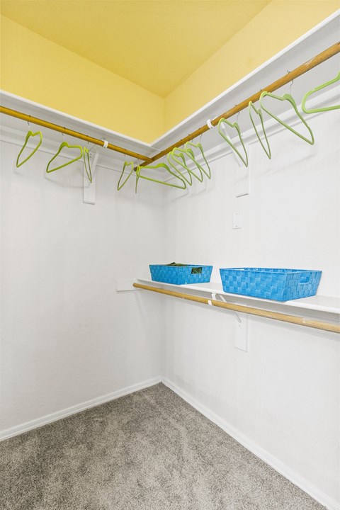 a laundry room with shelves and baskets on the wall