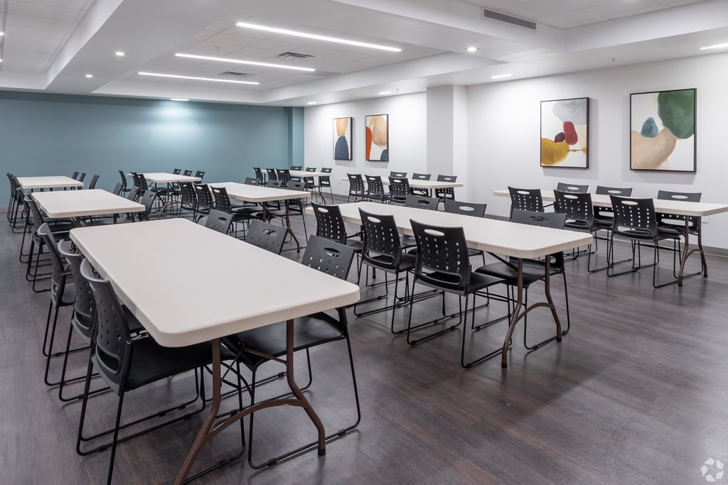 A room with tables and chairs set up for an event.