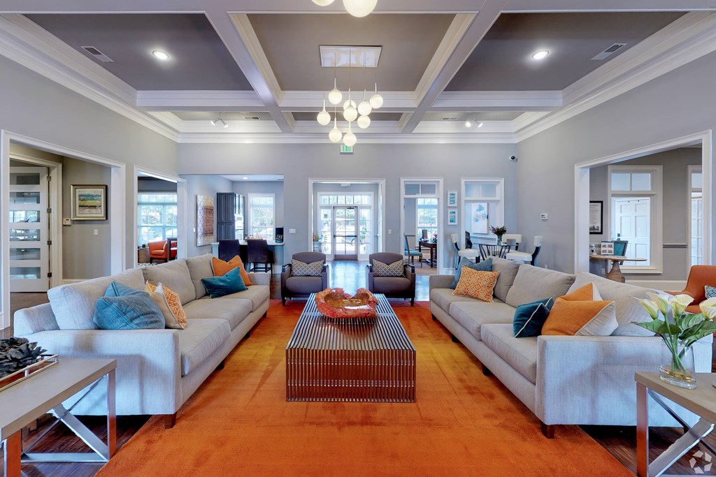 A modern living room with a large sofa set and a coffee table.