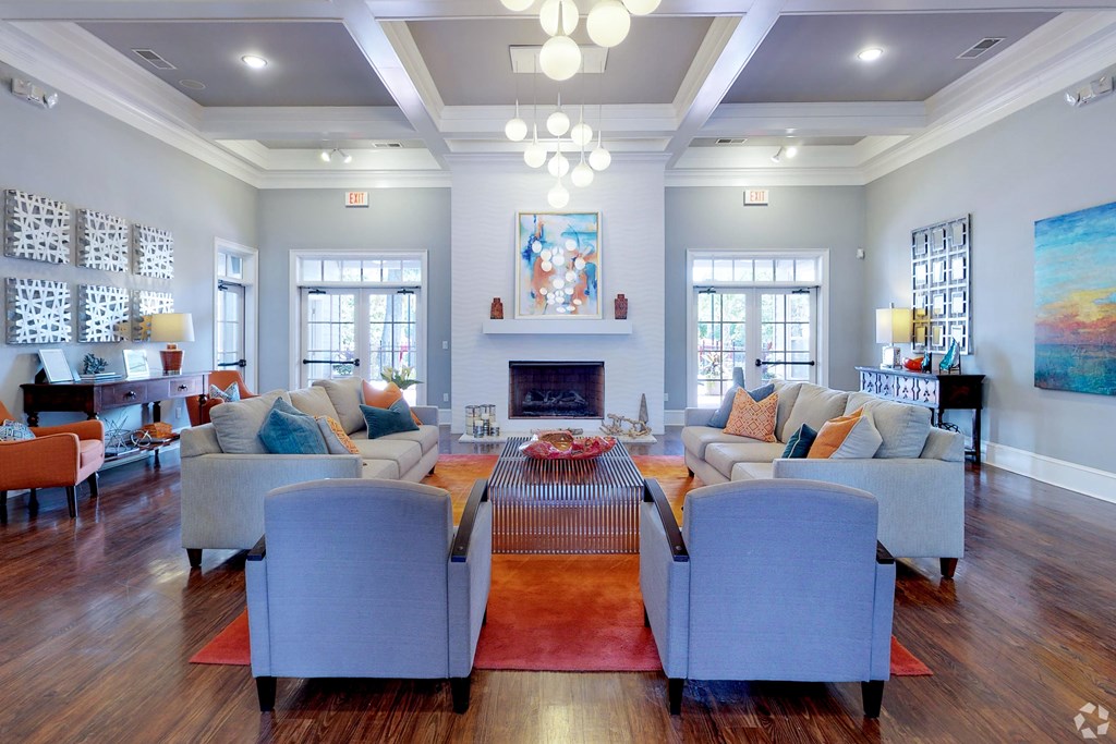 A living room with a fireplace and a painting on the wall.