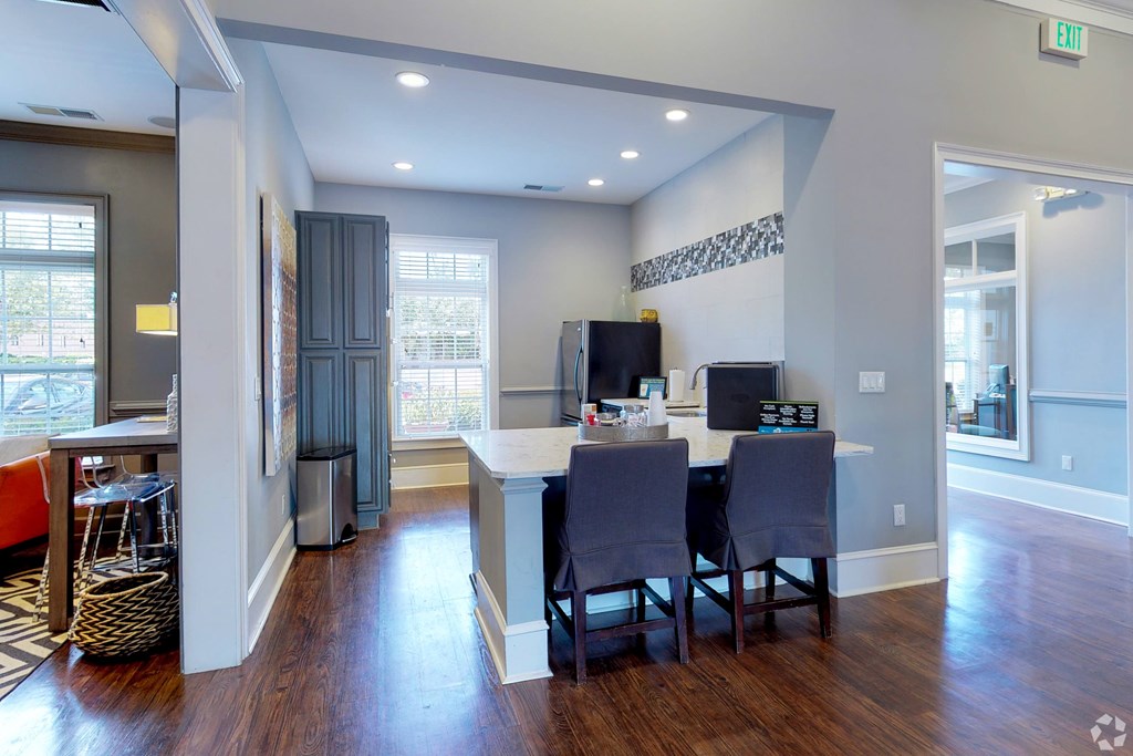 A kitchen with a dining table and chairs.