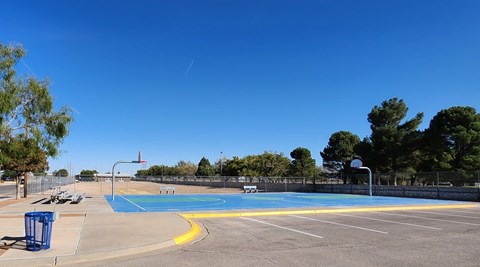 A blue and yellow pool with a fence around it.