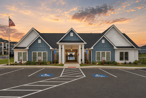 Exterior of the leasing office and clubhouse at dusk.