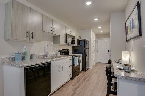 A modern kitchen with a dining area.