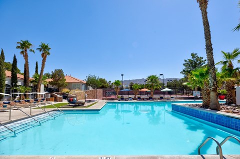 the pool at the club at reunion apartments with palm trees