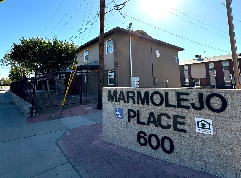 The image shows a building with a sign that reads "MARMOLEJO PLACE 600".