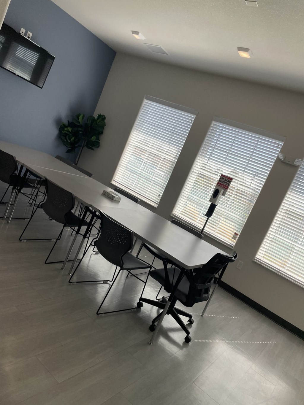 A conference room with a long table and chairs.