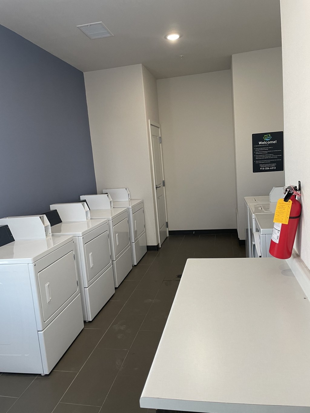 A row of washing machines in a laundromat.