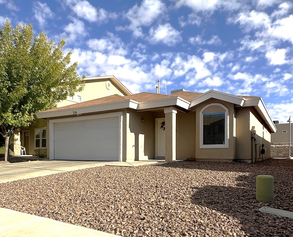 A house with a garage and a driveway.