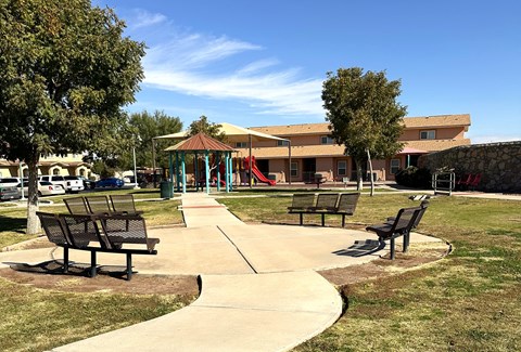 A park with a playground and benches.