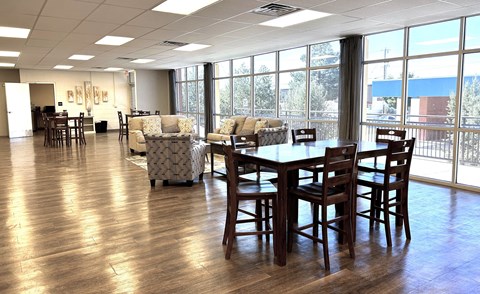 A large room with a long table and chairs.