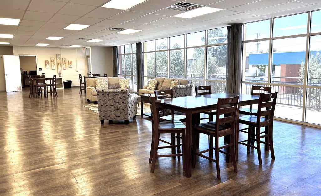 A large room with a long table and chairs.