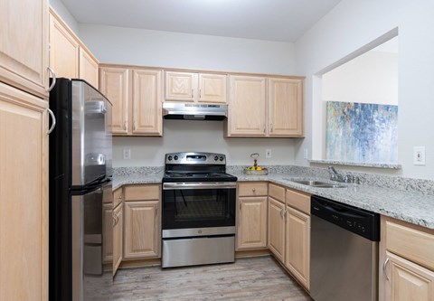 A kitchen with wooden cabinets and stainless steel appliances.