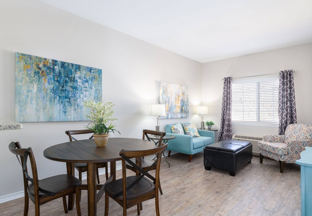 A dining room with a table set for four.