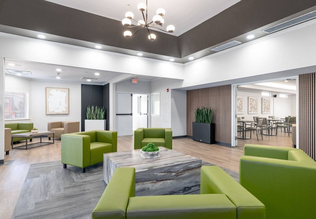 A modern living room with green and grey furniture.