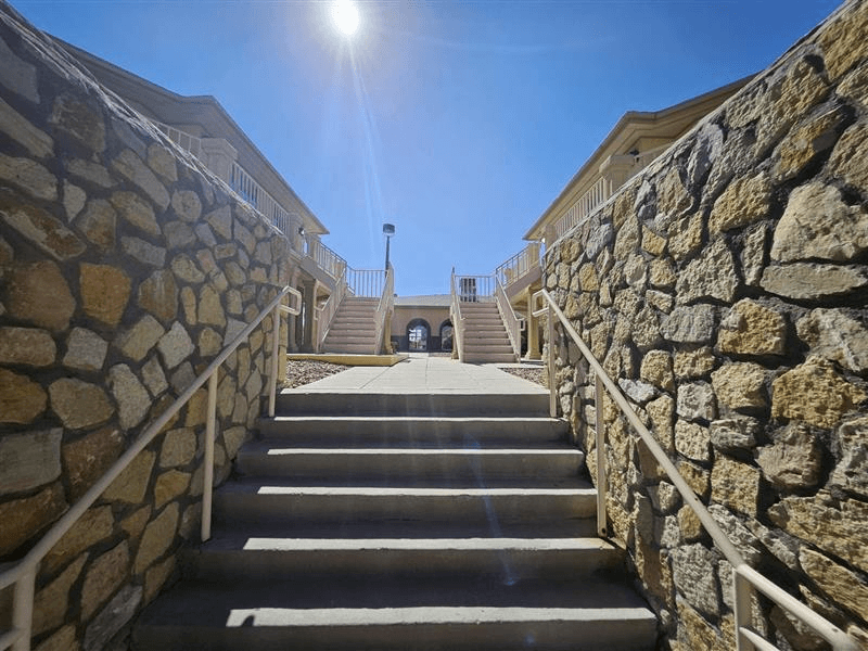 A stone staircase leads up to a building entrance.