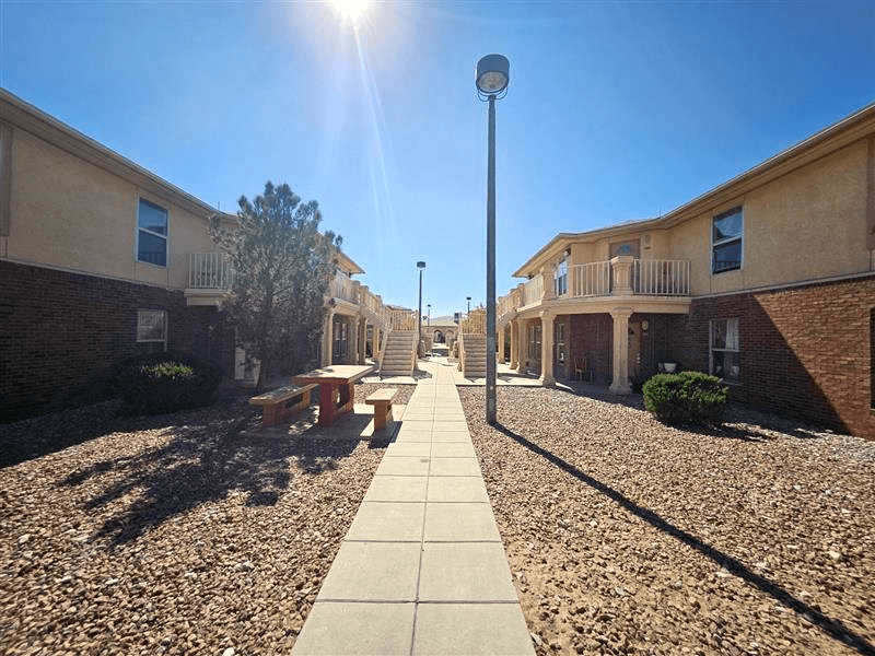A sunny day in a residential area with a clear blue sky.