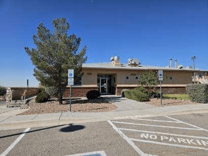 A building with a NO PARKING sign in front of it.