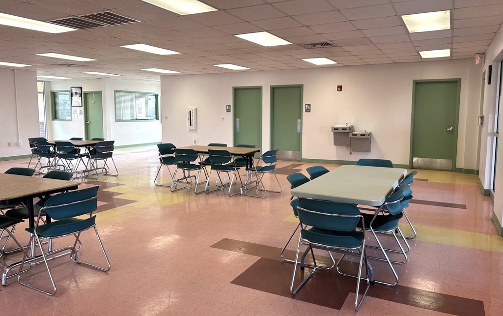 A classroom with tables and chairs.