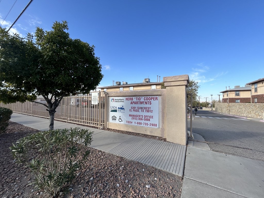 A sign for the USDA Housing and Urban Development apartments is displayed on a wall.