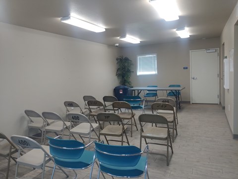 A room with blue chairs and a table with numbers on them.