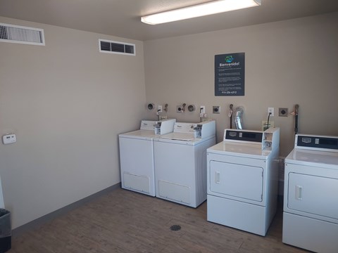A laundromat with washers and dryers in it.