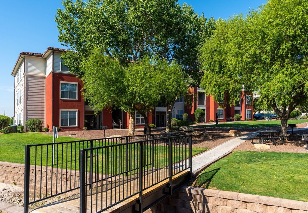 A row of houses with a black fence in front.