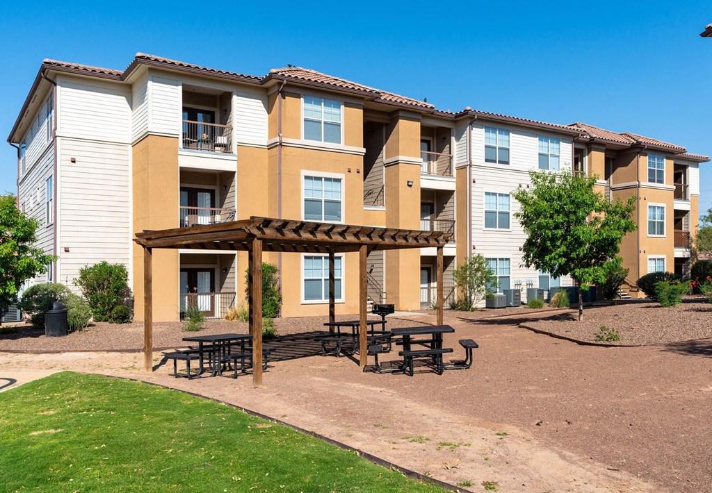 Apartment complex with a covered patio area.
