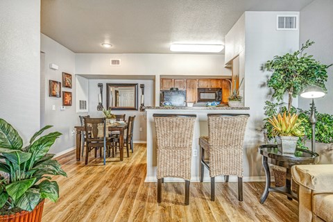 A dining room with a wooden table and chairs.