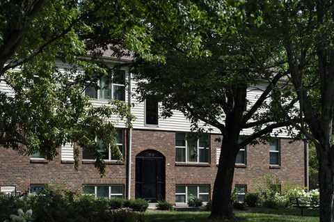 a red brick building with trees in front of it