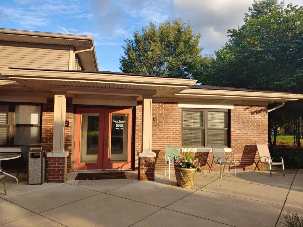 a patio in front of a brick house
