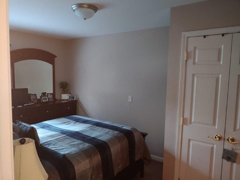 a bedroom with a bed and a dresser