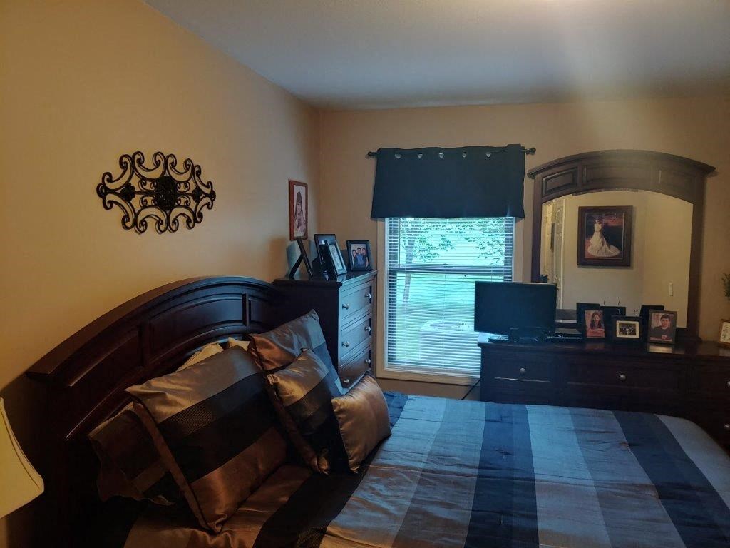 a bedroom with a bed and a dresser in it