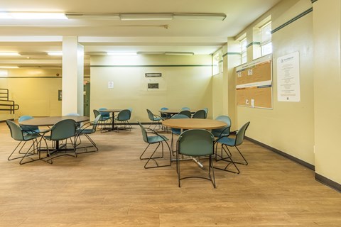 A conference room with a long table and chairs.