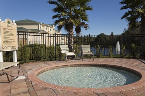 A pool with a sign that says "NO DIVING" in front of a house.