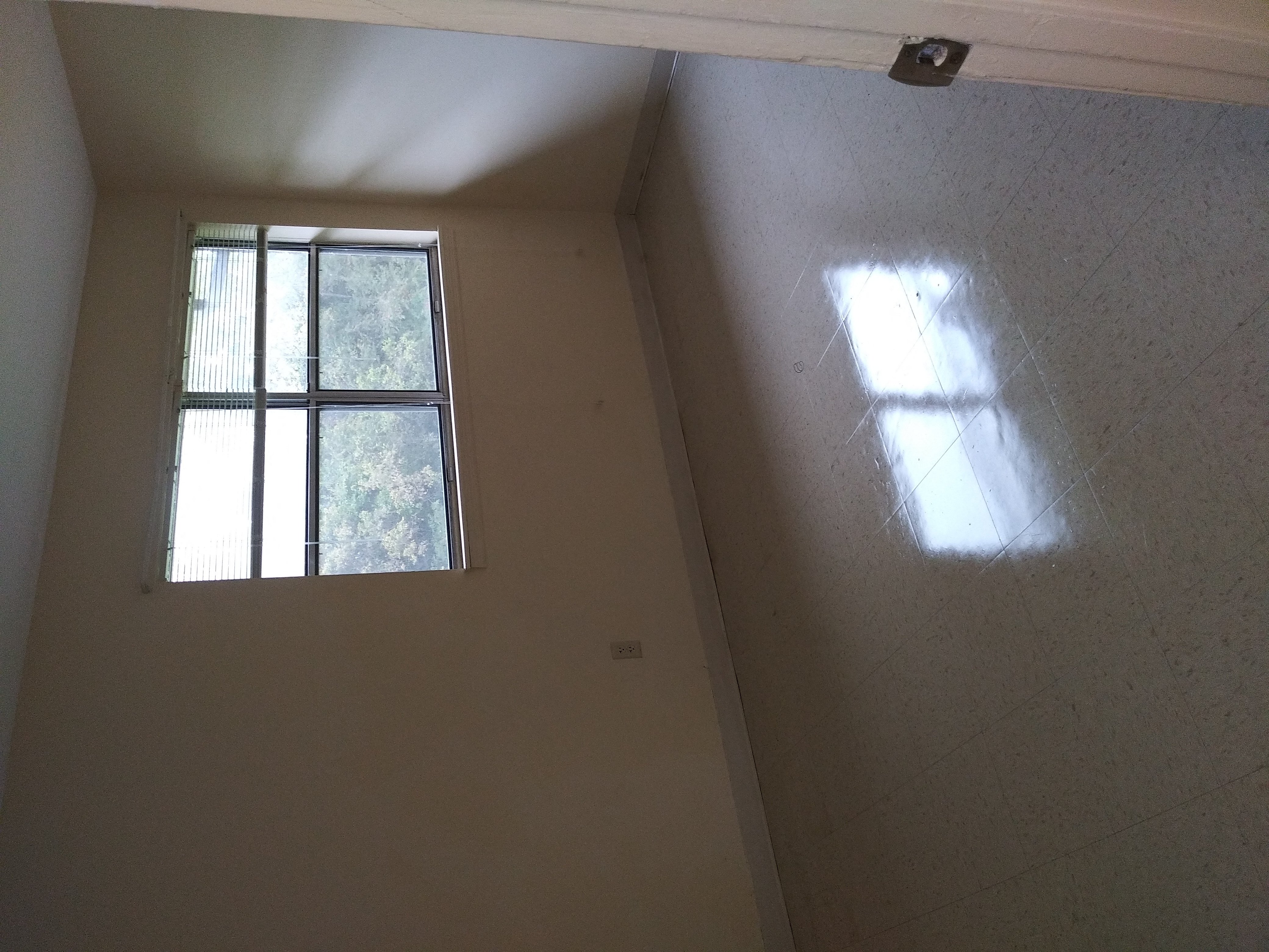 a window on the wall of a room in a house