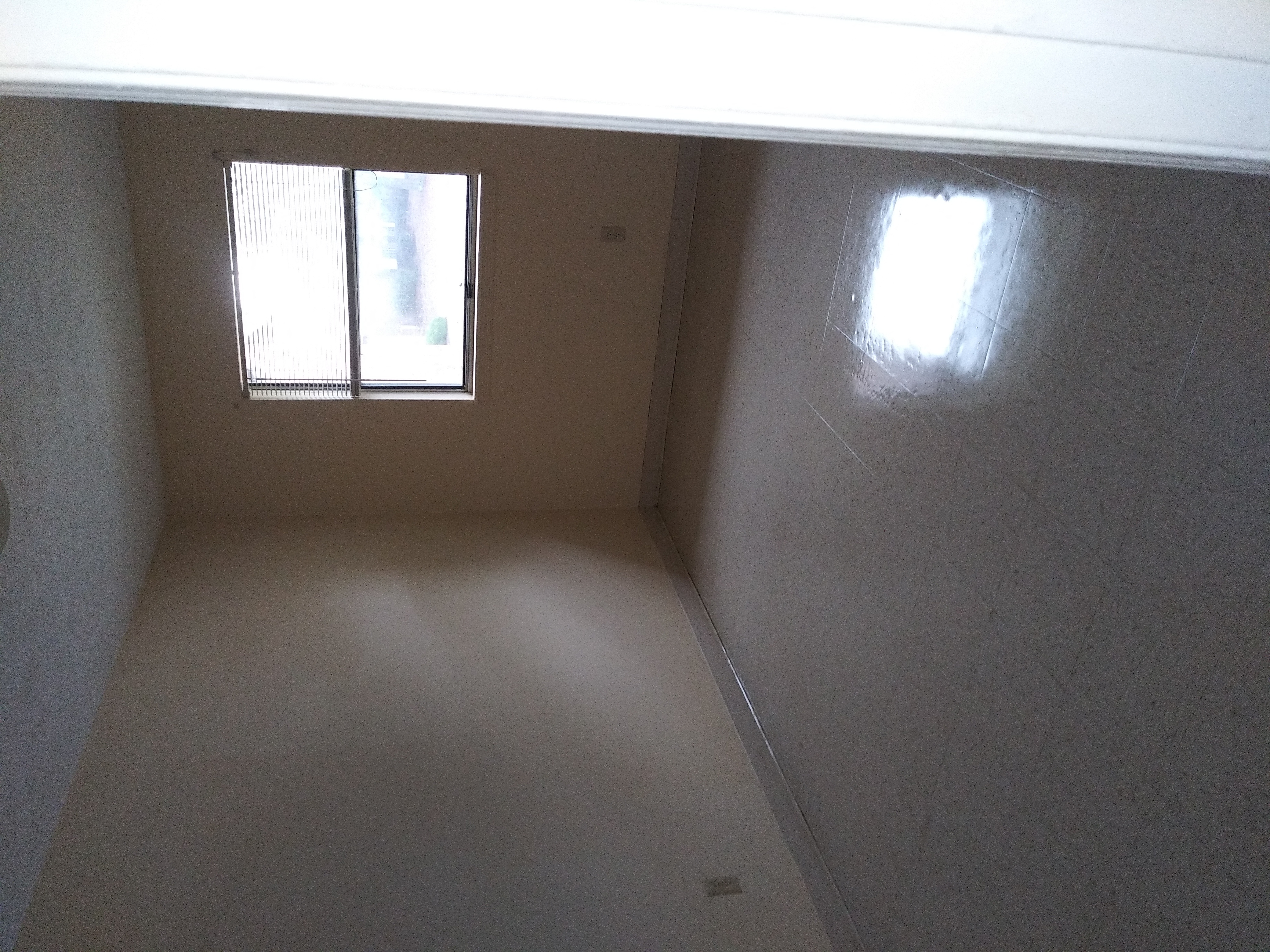 an empty room in a house with a window