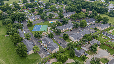 an aerial view of a neighborhood with houses and a tennis court