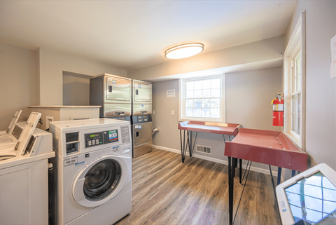 a laundry room with a washing machine and a table