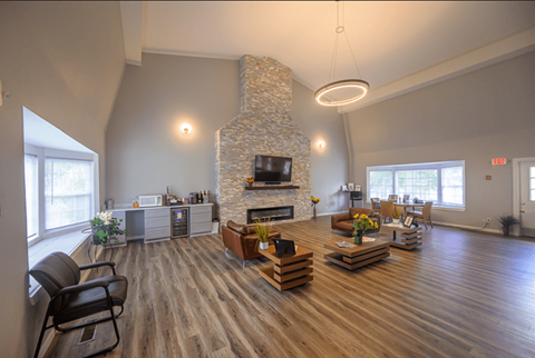 Modern apartment clubhouse with fireplace and seating area