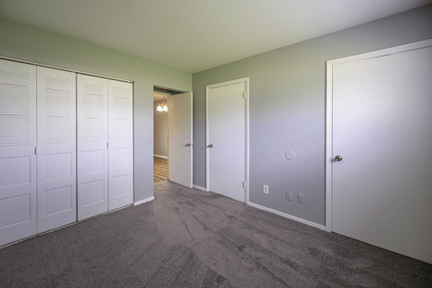 Empty bedroom with carpet and large closet