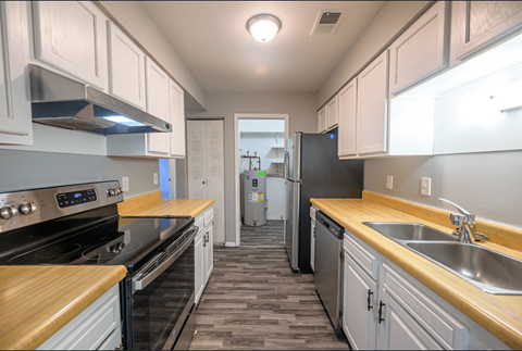 a kitchen with wood counter tops and stainless steel appliances