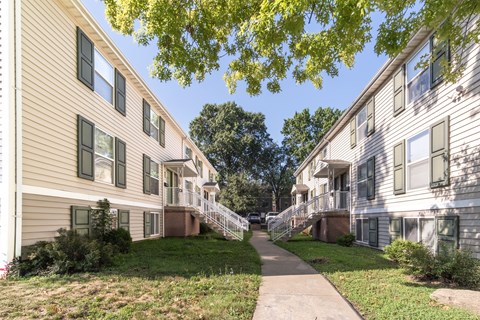 A residential area with apartment buildings and a pathway.