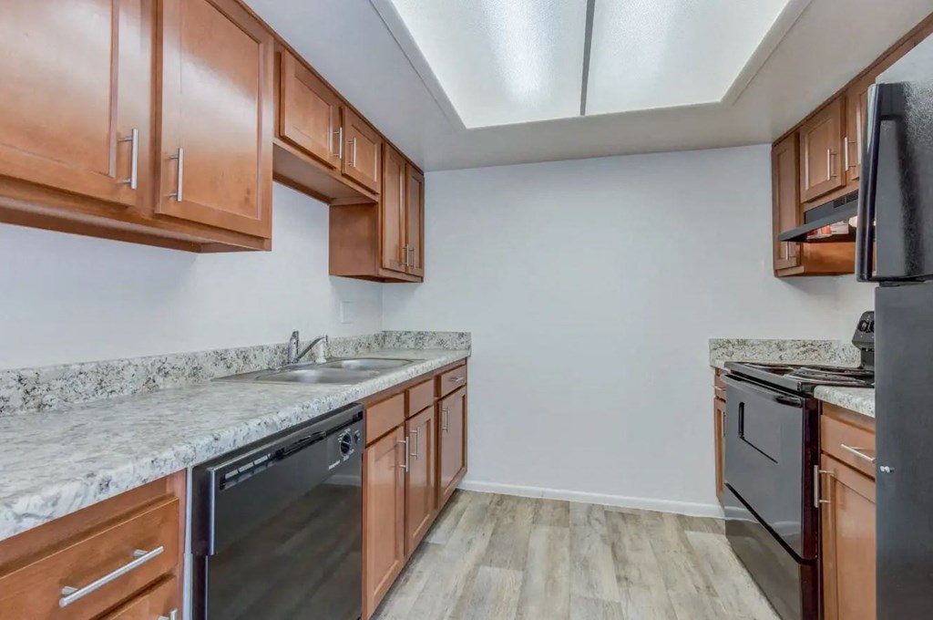 a kitchen with wood cabinets and granite countertops