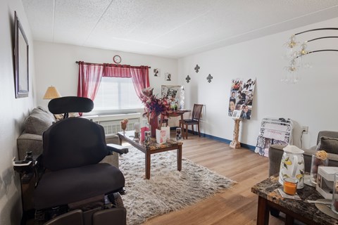 A living room with a grey chair and a coffee table.