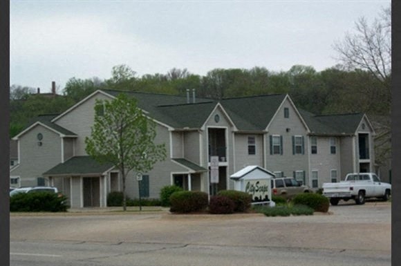 a large apartment building with a sign in front of it