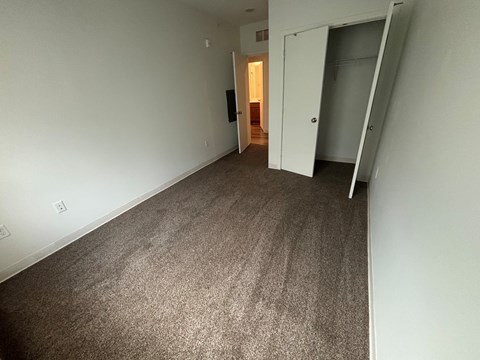 A room with carpeted floor and white walls.