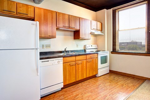 A kitchen with wooden cabinets and white appliances.