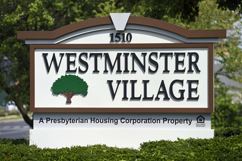a sign is shown in front of trees