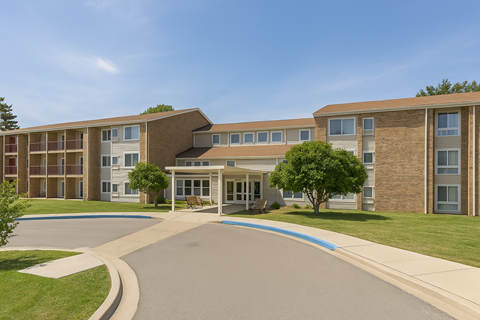 A large building with a driveway in front of it.